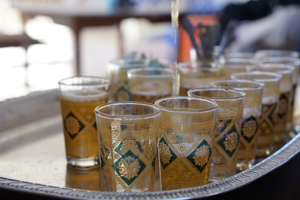 A vibrant Moroccan tea ceremony with ornate glasses in Drâa-Tafilalet.