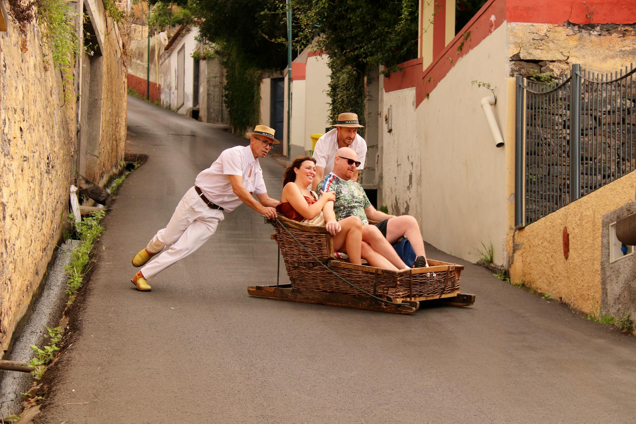 Experience the thrilling traditional wicker toboggan ride down Funchal's steep streets in Madeira, Portugal.