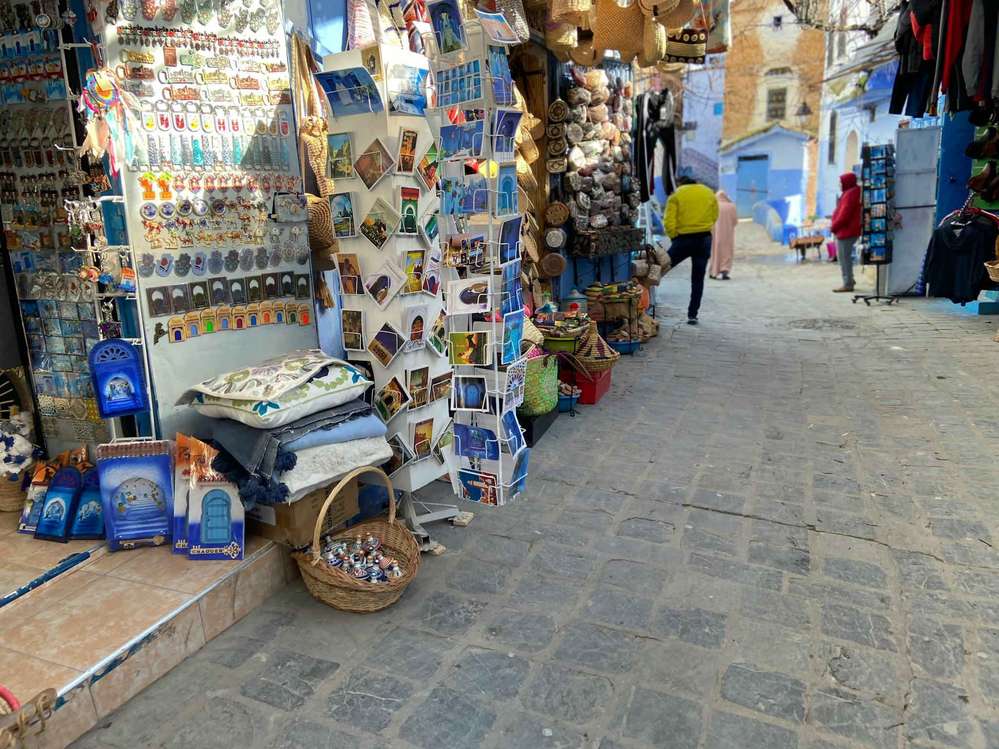 Explore the colorful bazaar in Chefchaouen, Morocco, filled with souvenirs and local crafts.