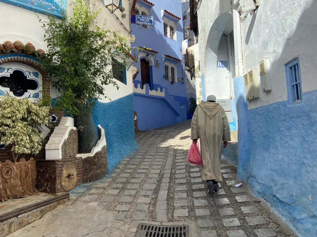 Explore the picturesque blue architecture of Chefchaouen's narrow cobblestone alleyways.